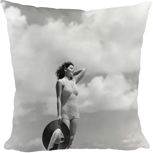 Woman Wearing Knit Bathing Suit Standing Wall Ocean Sea Background Holding Sun Hat Beach Bag Sail Boat Fashion Beauty Style Swim Wear Retro