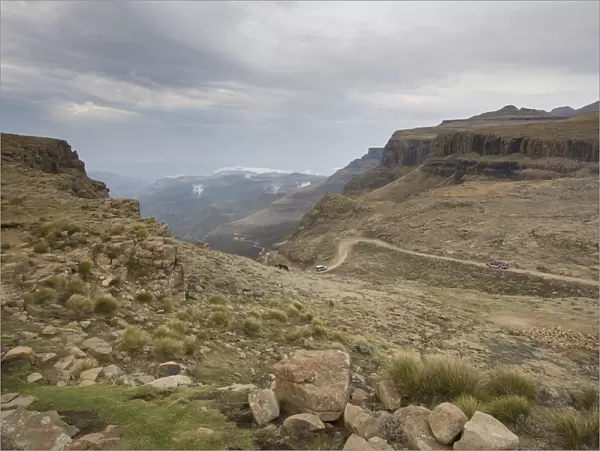 Landscape shot of 4x4 vehicles driving Sani Pass on the border of KwaZulu-Natal, South Africa and Thaba-Tseka, Lesotho