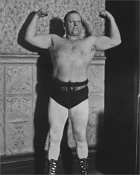 Strongman. A strongman flexes his muscles, circa 1925