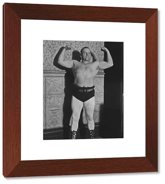 Strongman. A strongman flexes his muscles, circa 1925