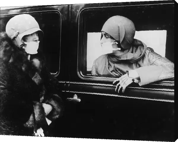 Flu Masks. Two women wearing flu masks during the flu epidemic which followed