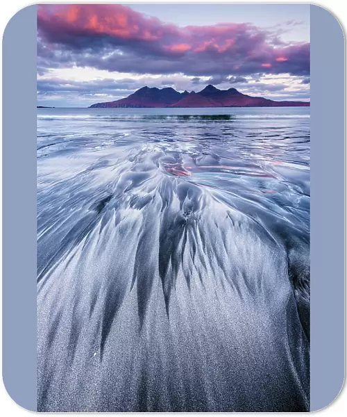 Stunning sand formations on the Isle of Eigg with the Isle of Rum in the distance. Scotland