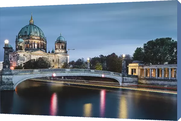 Berlin Cathedral on the Spree River with passing excursion steamer, light traces, dusk, Berlin, Germany