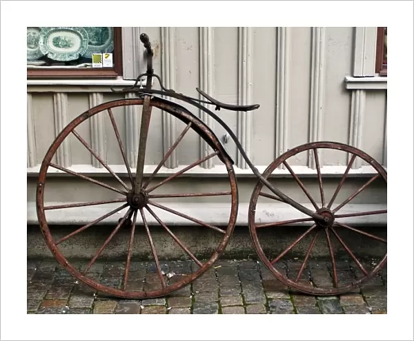 Early bicycle against wooden painted wall of antique shop in Haga district of Gothenburg