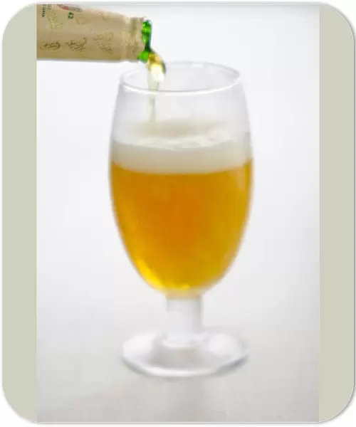 Pouring lager beer into stemmed beer glass credit: Marie-Louise Avery  /  thePictureKitchen