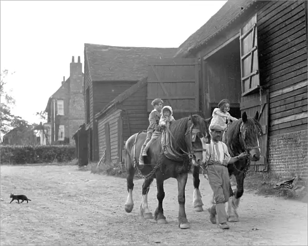 Farm scene: children on horses in the evening. 1934
