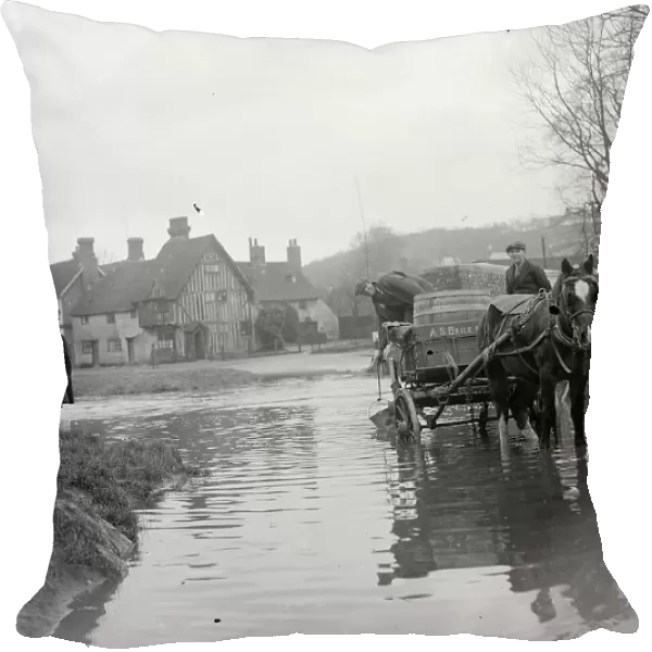 A horse and cart wades throug the ford at Eynsford in Kent watched by schoolboys