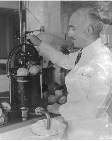 Dr A T Frascati an American scientist. Making perfume from crushed fruit. Photo shows