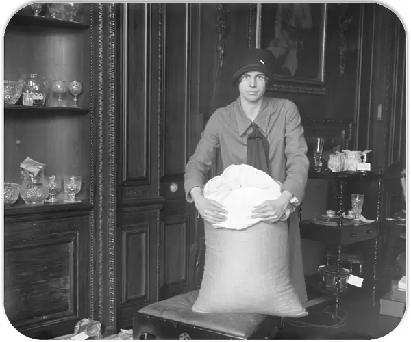 Miss Marjorie Pollock ( daughter of Sir Ernest and Lady Pollock ) with the sack of