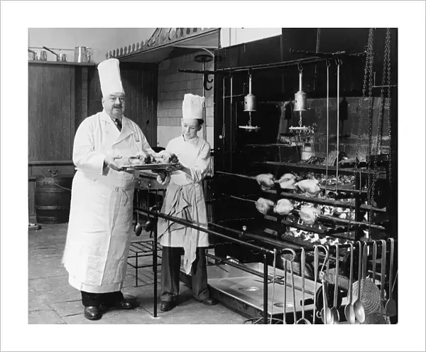 A. H. Cadier, senior chef at the Brighton Pavilion is handed fake chickens by junior