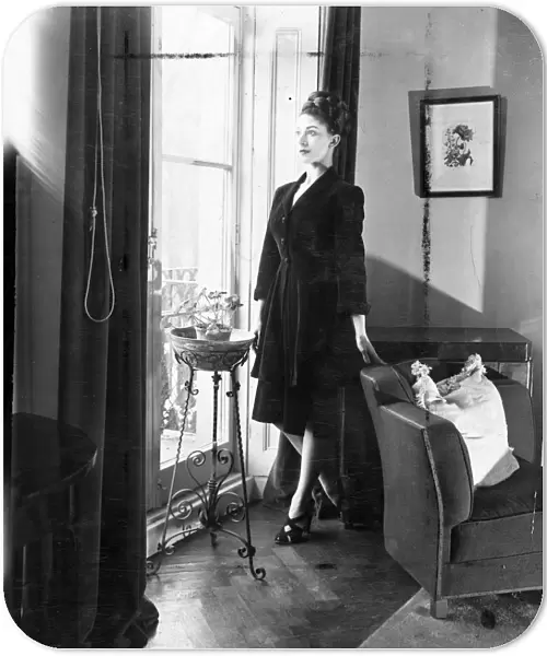 Margot Fonteyn at home. Margot Fonteyn, looks out into Pelham Cresent from the french