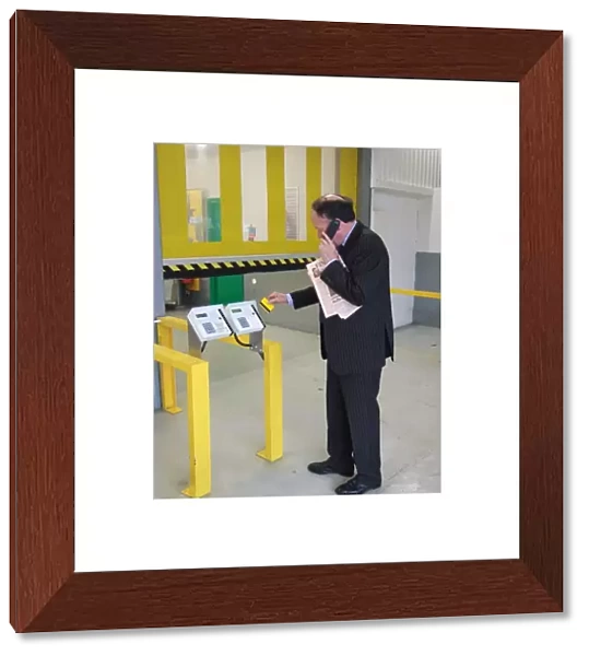 Business man entering a building using a swipe card. ?TopFoto