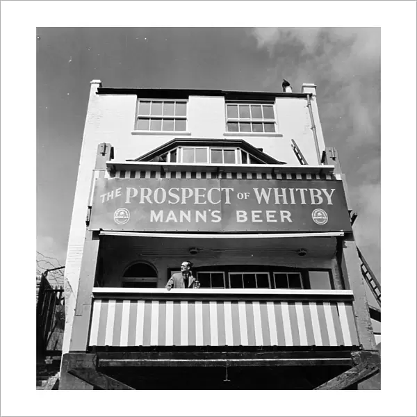 Pub and large sign for The Prospect of Whitby, Wapping, London, England 1951