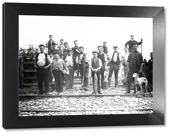 Group of men and boys on a railway track, possibly Padstow-Wadebridge branch line, Cornwall. Early 1900s