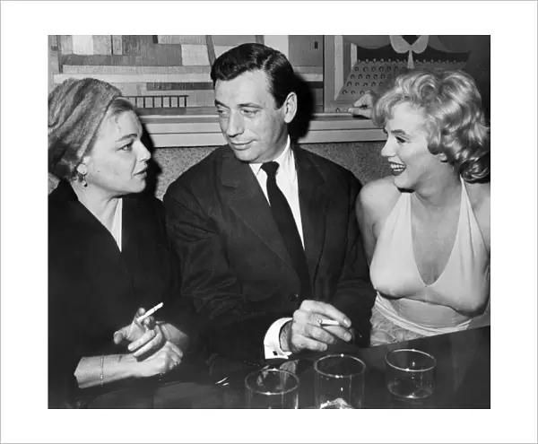 French actors Simone Signoret and her husband Yves Montand Chat with American Star Marilyn Monroe