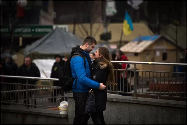 A couple stands on Independence square in Kiev, on February 14, 2014