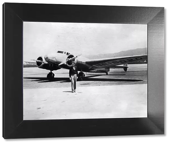 Amelia Earhart in front of her plane