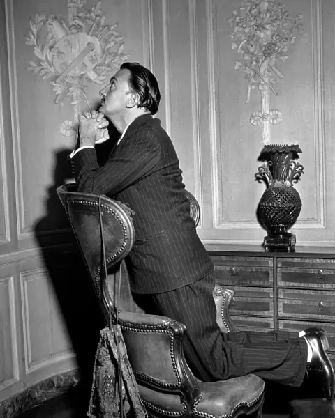 Salvador Dali Poses in front of one his paintings