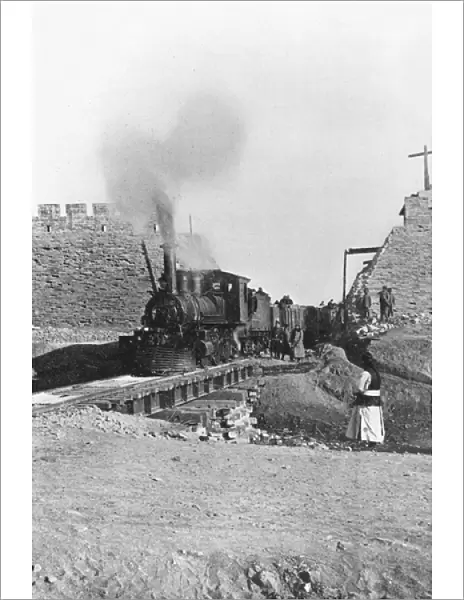 First train passing through the wall of Peking, China, c. 1900 (b  /  w photo)
