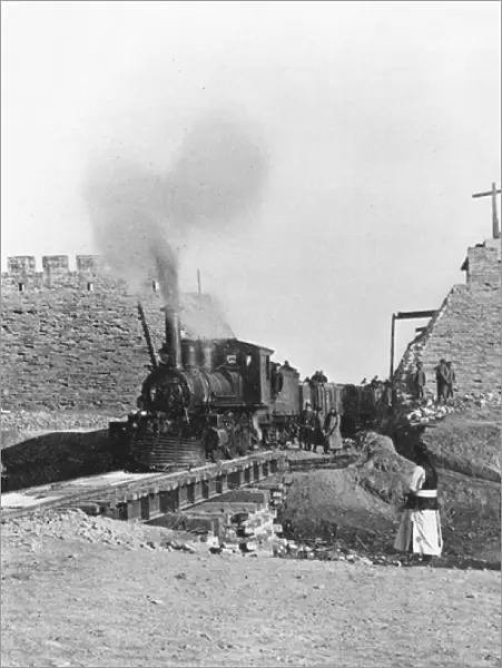 First train passing through the wall of Peking, China, c. 1900 (b  /  w photo)