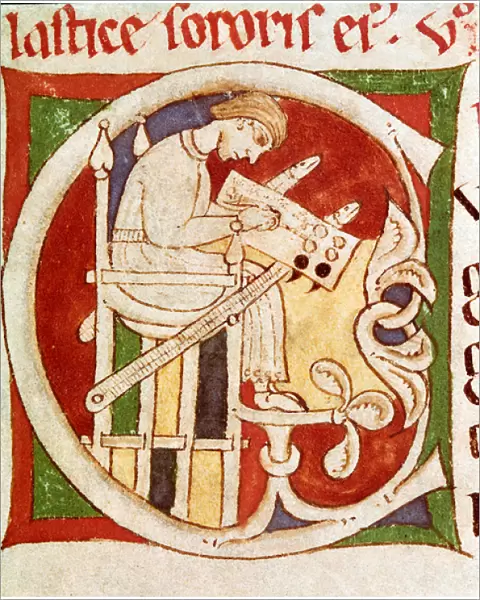 Letter C adorned with a monk writing on a desk. Miniature from '