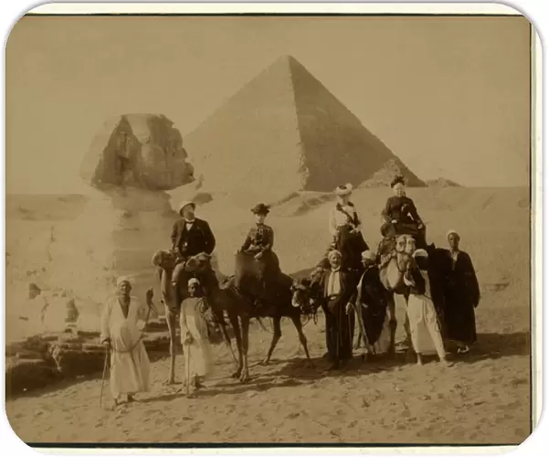 Tourists on camels in front of The Great Pyramid and Sphinx at Gaza, Egypt, pub