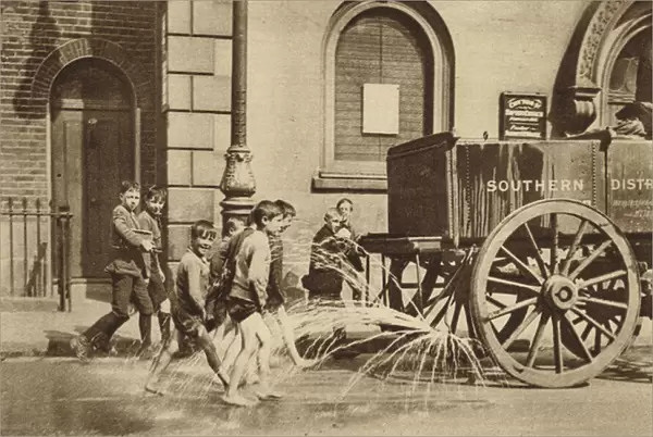 Children in Poplar enjoying the passing of a water cart during a heatwave (b  /  w photo)