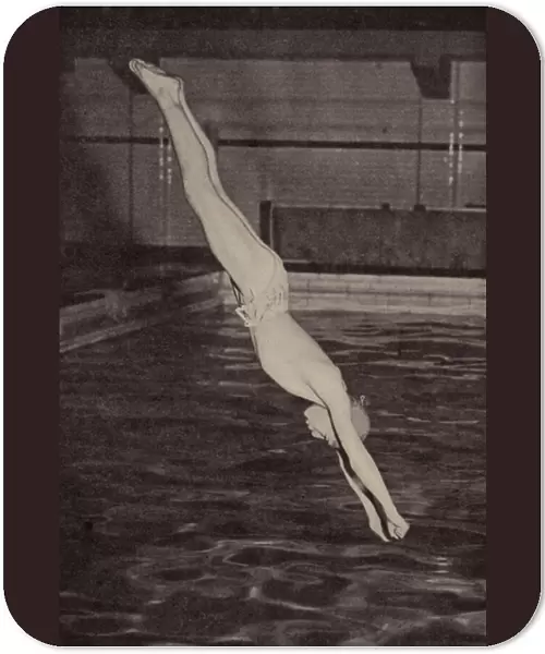 Boy diving into a swimming pool (b  /  w photo)