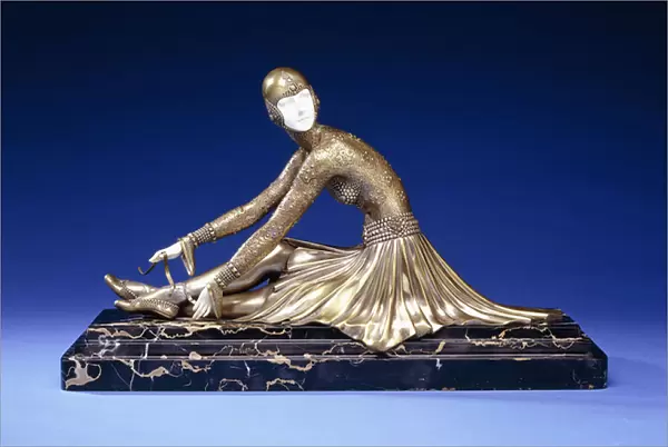 Tamara, a Figure of a Ballerina Tying her Shoe, early 20th century (gilt-bronze, silvered, ivory, veined black marble base)