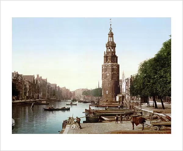 View of Oude Schans (New Canal), Amsterdam, Holland, 1890-1900. The Montelbaanstoren, built in 1512, housed the city's military guard and is part of Amsterdam's old defences. Netherlands Transport Water Trade Quay Architecture