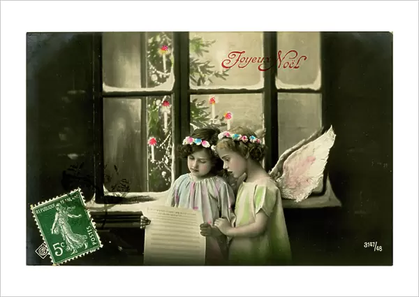 Postcard, Christmas greeting: Chant of two angels reading a score in front of a snow-covered window. The beginning of the 20th century