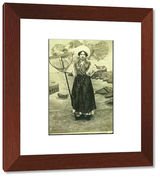 France, Nord-Pas-de-Calais, Pas-de-Calais (62), Boulogne-sur-Mer: Young woman in traditional dress from the Boulogne-sur-Mer region with a shrimp cap and net, 1905