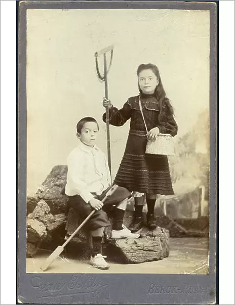 France, Nord-Pas-de-Calais, Pas-de-Calais (62), Berck: Two children pose in studio with their shrimp fishing equipment, 1890