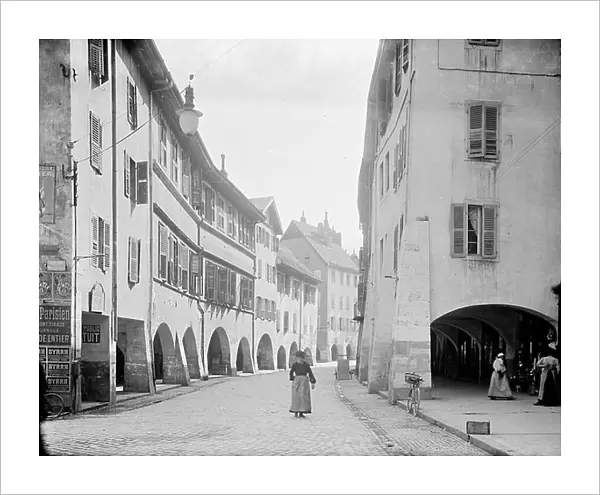 France, Rhone-Alpes, Haute-Savoie (74), Annecy: view of a street in the city center with shops, arcades, 1900