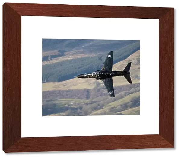 A Hawk T1 trainer aircraft of the Royal Air Force low flying over North Wales
