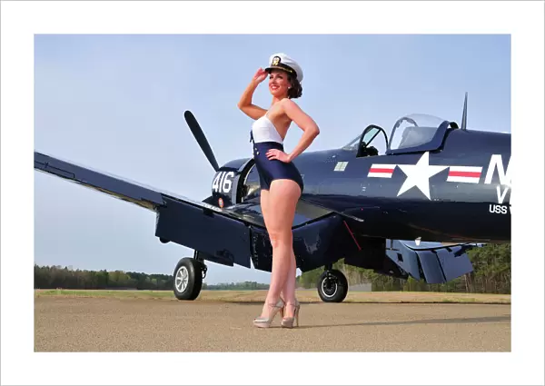 1940s style Navy pin-up girl posing with a vintage Corsair aircraft