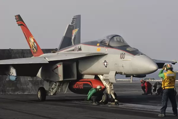 An F  /  A-18E Super Hornet moving to the catapult aboard USS George H. W. Bush