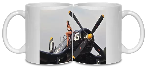 1940s style Navy pin-up girl sitting on a vintage Corsair fighter plane