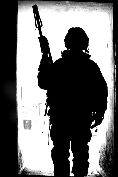 Silhouette of a British soldier in a doorway at Camp Condor, Iraq