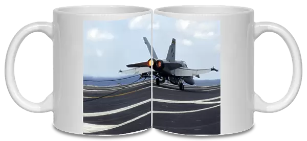 An F  /  A-18C Hornet successfully lands on the flight deck of USS John C. Stennis