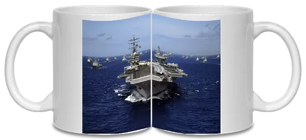 Aircraft carrier USS Ronald Reagan leads a mass formation of ships through the Pacific