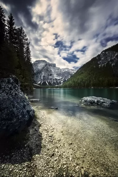 Lake Braies and Dolomite Alps against stormy clouds, Northern Italy