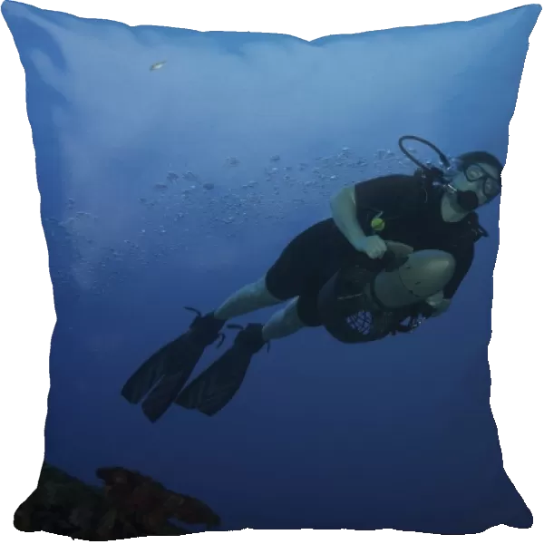 Scuba diver uses a diver propulsion vehicle off the coast of Bonaire, Caribbean Netherlands