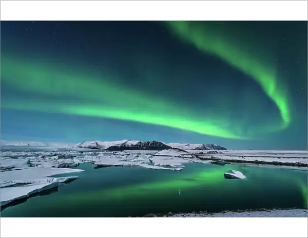 The northern lights dance over the glacier lagoon in Iceland