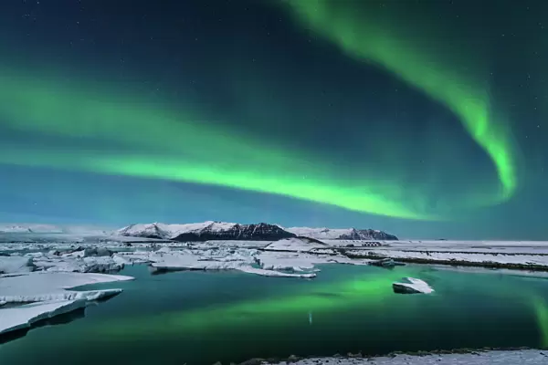 The northern lights dance over the glacier lagoon in Iceland
