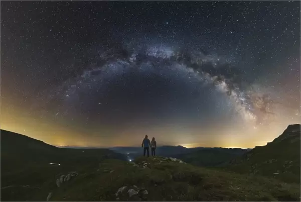 A couple gazing at the Milky Way from atop the Lago-Naki plateau overlooking Russia
