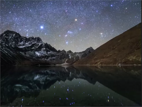 Celestial sky with Sirius, Orion and Aldebaran shining bove Pharilapche Peak in Nepal