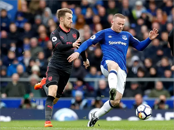 Rooney vs. Ramsey: Intense Battle for the Ball at Goodison Park - Premier League: Everton vs. Arsenal