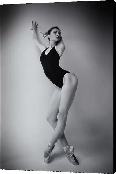 ballerina in a bodysuit improvises classical and modern choreography in a photo studio