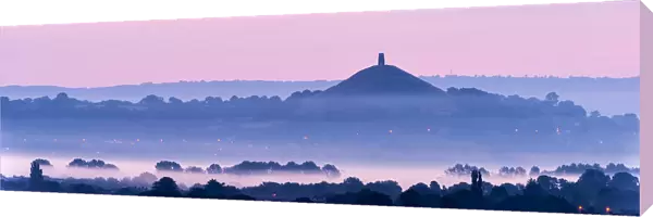 View towards Glastonbury Tor with low lying mist at dawn from Waltons Hill, Glastonbury